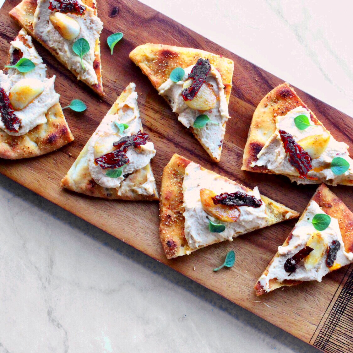 Pita and Hummus Triangles with Roasted Garlic, Sun Dried Tomatoes and Oregano
